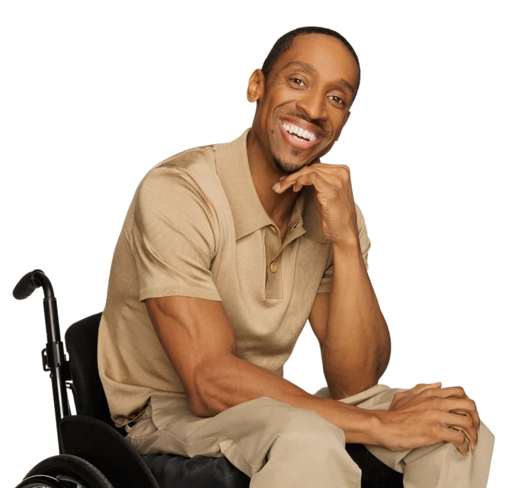 Disabled man in wheelchair smiling at the camera