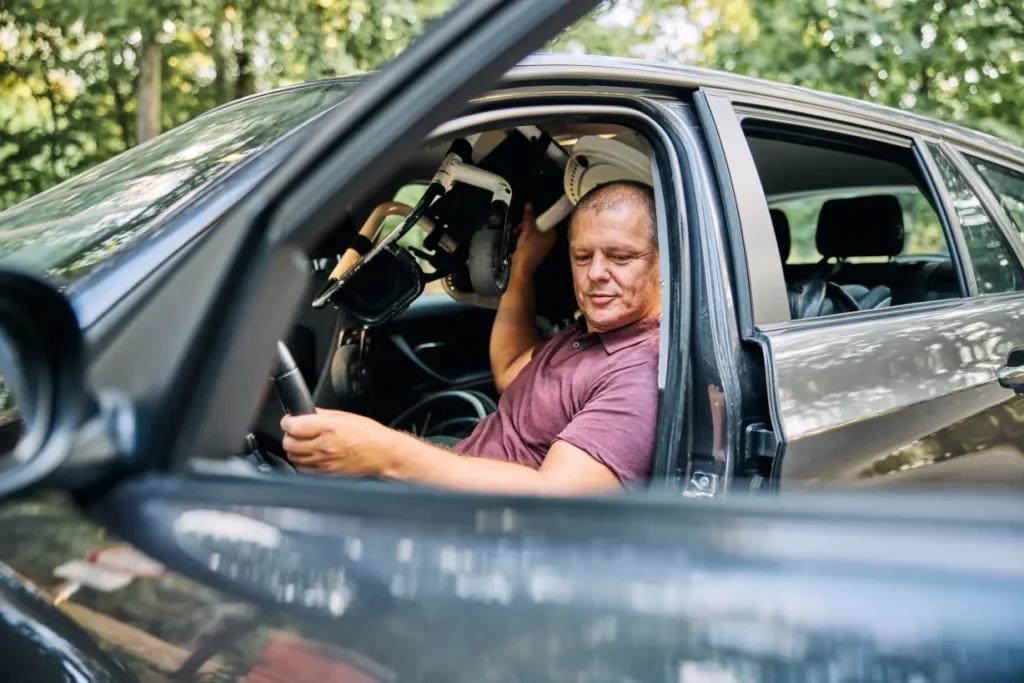 Disabled man getting out of car